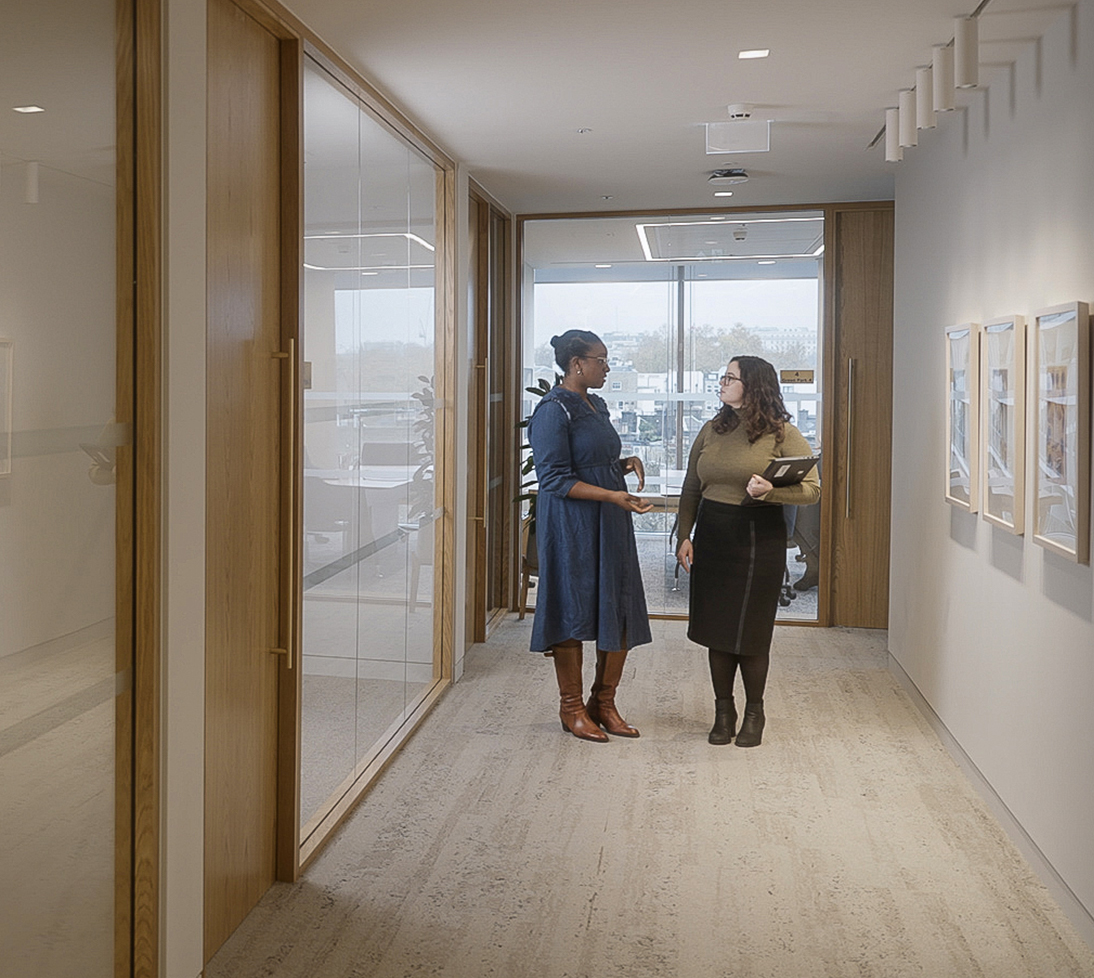 Julie & Oyin in chatting in hallway