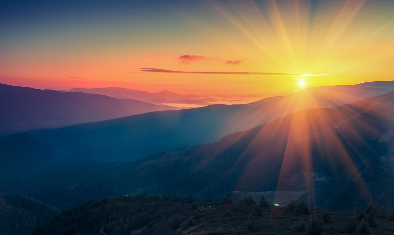 Panoramic view of  colorful sunrise in mountains. Filtered image:cross processed vintage effect.